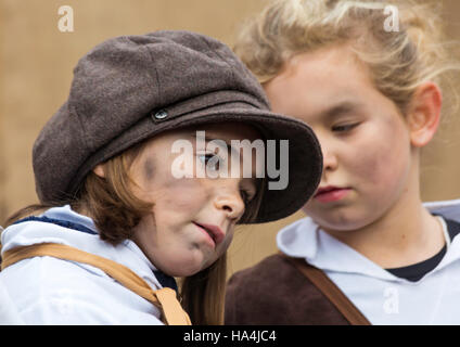 Portsmouth, Hampshire, UK 27 November 2016. Thousands visit the Victorian Festival of Christmas at Portsmouth Historic Dockyard for the entertainment, characters dressed in olden days and the Christmas market. Cheeky street urchins sing to the crowds. Credit:  Carolyn Jenkins/Alamy Live News Stock Photo