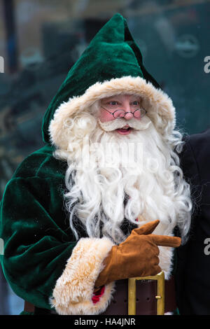 Portsmouth, Hampshire, UK 27 November 2016. Thousands visit the Victorian Festival of Christmas at Portsmouth Historic Dockyard for the entertainment, characters dressed in olden days and the Christmas market.  Father Christmas, Santa Claus, dressed in Victorian green costume. Credit:  Carolyn Jenkins/Alamy Live News Stock Photo