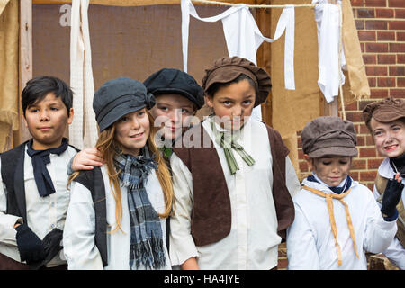Portsmouth, Hampshire, UK 27 November 2016. Thousands visit the Victorian Festival of Christmas at Portsmouth Historic Dockyard for the entertainment, characters dressed in olden days and the Christmas market. Cheeky street urchins sing to the crowds. Credit:  Carolyn Jenkins/Alamy Live News Stock Photo