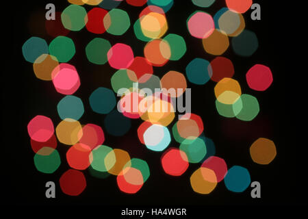 Defocused red, yellow, magenta, blue, green, pink lights on black background Stock Photo