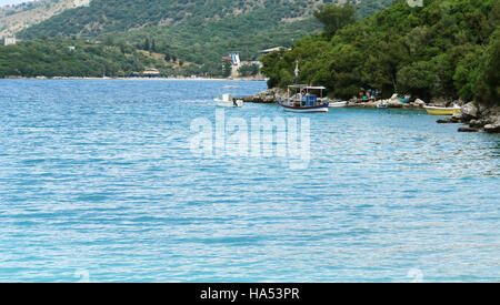 View from the beach with fishing-boat on the Ionian Sea. Stock Photo