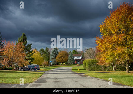 Storm clouds over peaceful suburban neighborhood Stock Photo