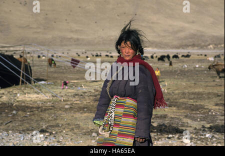 A young Khampa nomad outside her family's tent on the vast grasslands of Litang in eastern Tibet. The nomads of China face an uncertain future. Strang Stock Photo