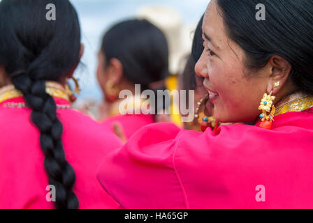 A Khampa horseman practises picking up silk scarves from the back of a galloping horse at the Yushu Horse Racing Festival in Qinghai. Otherwise known  Stock Photo