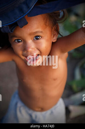 CEBU,PHILIPPINES-OCTOBER 18,2016: Little boy plays with tourists on the streets of the carbon market on October 18, Cebu,Philippines. Stock Photo