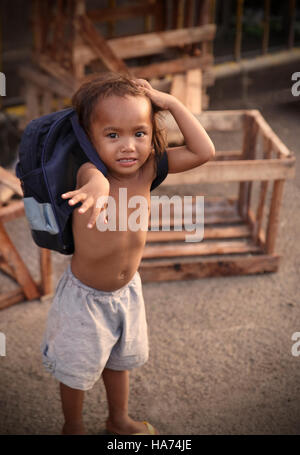 CEBU,PHILIPPINES-OCTOBER 18,2016: Little boy plays with tourists on the streets of the carbon market on October 18, Cebu,Philippines. Stock Photo