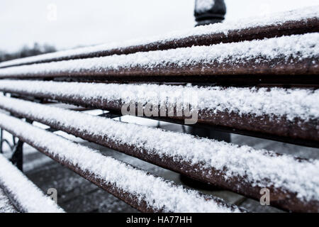 Closeup Frozen bench covered gritty rough hoarfrost on a cloudly winter day Stock Photo