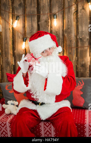 Santa Claus: Cheerful With Small Stack Of Gifts Stock Photo