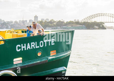 A grandad or older dad with two children on a ferry in Sydney Harbour Stock Photo