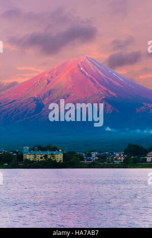 Colorful pink sky above the red volcano crater cone of Mount Fuji over Lake Kawaguchiko water on a summer morning sunrise in Jap Stock Photo
