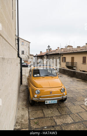 Old and new. The Fiat Cinquecento is ideal for the narrow streets of San Marino, Italy. In the background is a new model of the iconic vehicle. Stock Photo