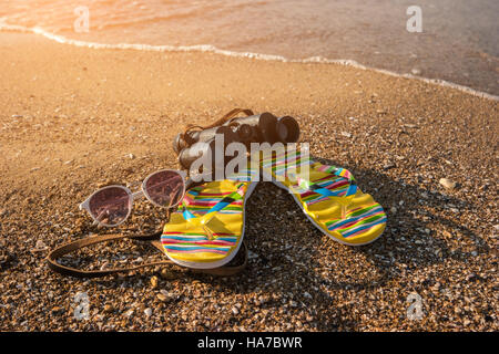 Binoculars with flip flops. Stock Photo
