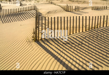 sandy ocean beach with beach fencing in the dunes Stock Photo