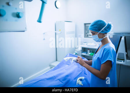 Nurse wearing surgical gloves in x-ray room Stock Photo