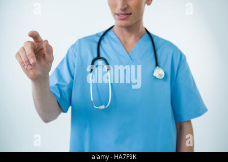Male nurse touching an invisible screen Stock Photo