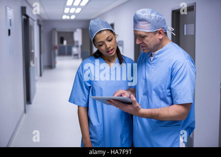 Surgeons discussing over digital tablet Stock Photo