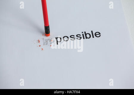Changing the word impossible to possible with a pencil eraser Stock Photo