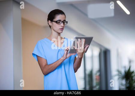 Female surgeon using digital tablet Stock Photo