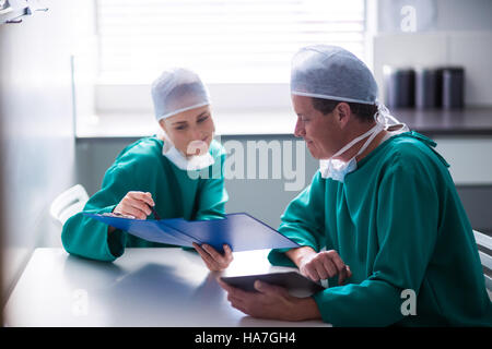 Surgeons having discussion on file Stock Photo