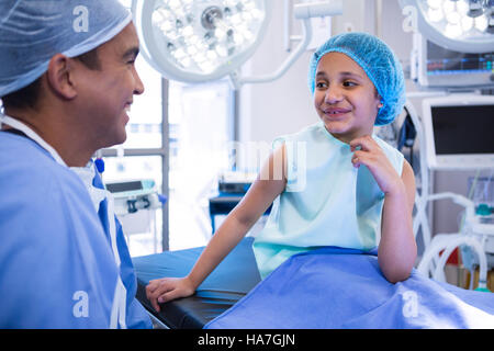 Doctor interacting with patient in operation room Stock Photo