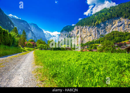Famous Lauterbrunnen valley with gorgeous waterfall and Swiss Alps in the background, Berner Oberland, Switzerland, Europe. Stock Photo