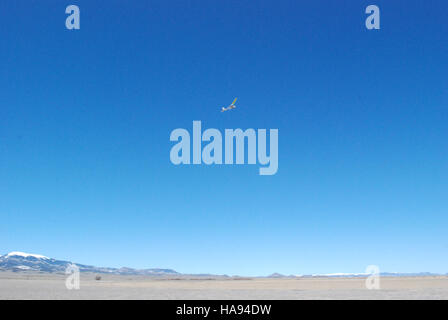 This image depicts an unmanned aircraft system (UAS) in flight over a national park. UAS technology is used for monitoring wildlife, mapping, and environmental data collection. It plays an important role in park management and conservation, aiding in research and preservation efforts. Stock Photo