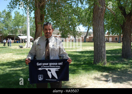 This image showcases Ron Garcia, a conservationist, engaged with a goose in a national park. The photo emphasizes the connection between humans and wildlife, highlighting efforts in wildlife protection and the importance of public awareness for environmental conservation. Stock Photo