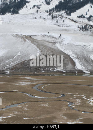 This photograph captures Meandering Flat Creek, a serene waterway in the mountain prairie region. The creek's winding path through the landscape highlights the natural beauty of the area. Stock Photo