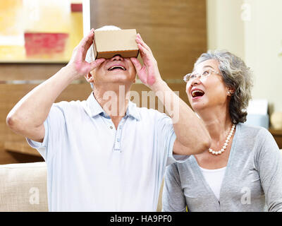 senior asian couple experiencing new technology by trying a vr device Stock Photo