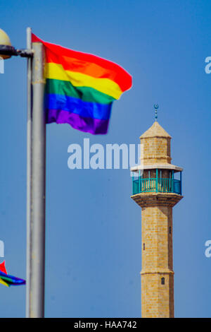 The minaret of Hassan Bek Mosque and a pride flag, in the day of the Pride Parade, in Tel-Aviv, Israel Stock Photo