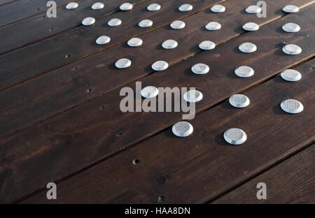 Outdoor wooden flooring with steel anti-slip elements Stock Photo