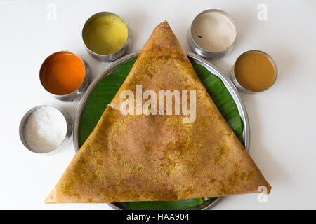 Close-up of Masala Dosa served on steel plate with  banana leaf underliner Stock Photo