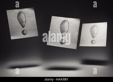 Exclamation marks drawn on paper, on gray background. Stock Photo