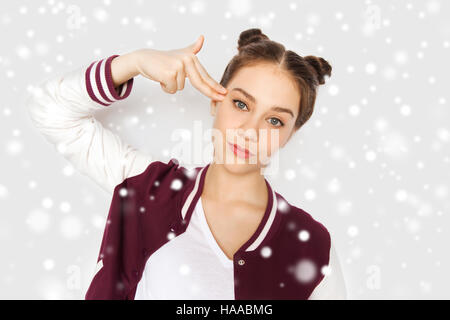 bored teenage girl making finger gun gesture Stock Photo