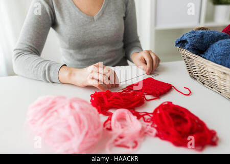 woman hands with knitting needles and yarn Stock Photo