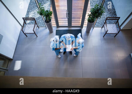 Surgeons discussing over medical reports Stock Photo