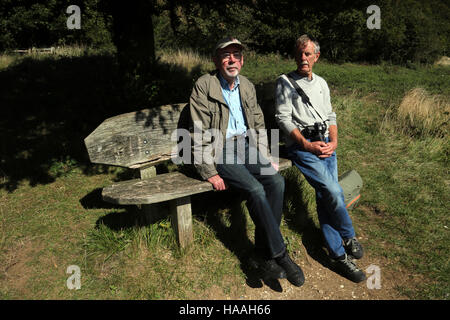 Surrey England Box Hill Two Men Sitting On Bench Under Tree Stock Photo