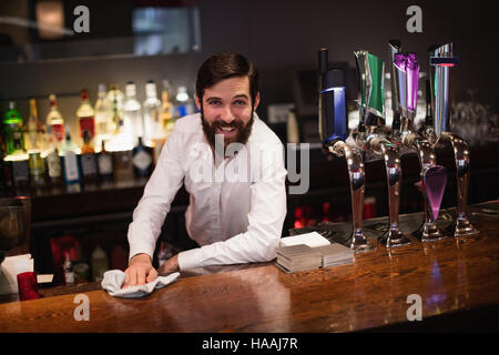 Bartender cleaning bar counter Stock Photo - Alamy