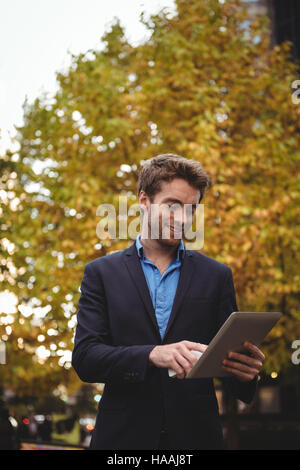Businessman holding mobile phone and using digital tablet Stock Photo