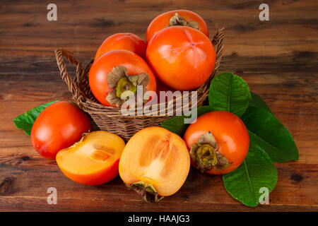 persimmon fruits in a basket Stock Photo