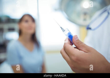 Doctor preparing a syringe to give an injection Stock Photo