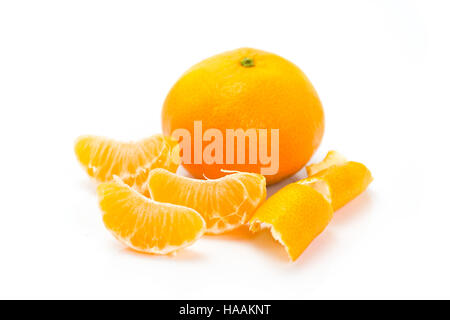 Whole and sliced mandarins on a white background Stock Photo