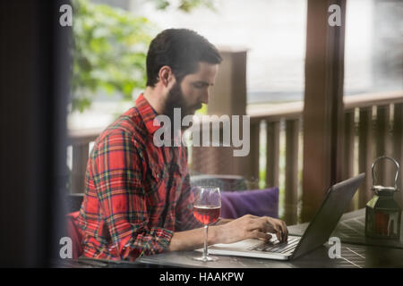 Man using laptop in bar Stock Photo