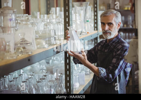 Glassblower examining glassware Stock Photo