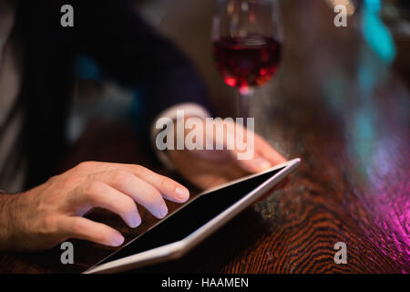 Businessman using digital tablet in bar counter Stock Photo