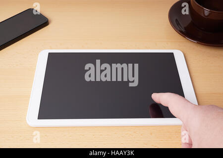 finger touching blank touchscreen on tablet computer Stock Photo