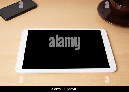 tablet computer with blank screen on desk Stock Photo