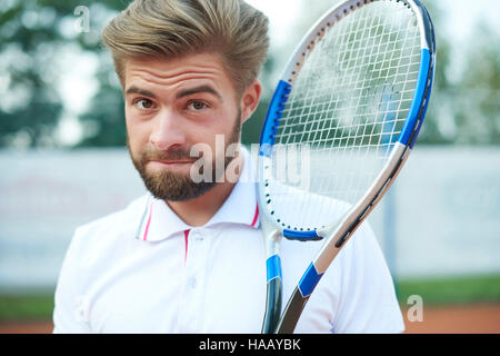 Handsome man with the racket Stock Photo