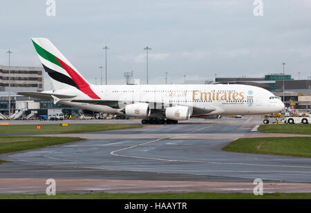 Emirates A380-861 double-decker wide-body passenger plane (A6-EDI) taxiing on Manchester International Airport tarmac. Stock Photo