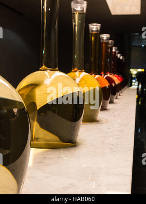 Wine's Various Tones, Bottles in Line with Different Hues, Colorful Glass Stock Photo
